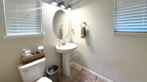 a bathroom with a sink mirror and vanity