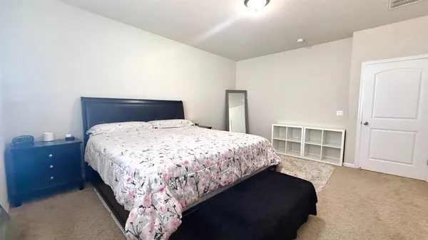 a bedroom with a large bed and walk in closet