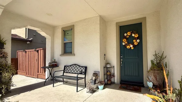 a balcony with furniture and a potted plant