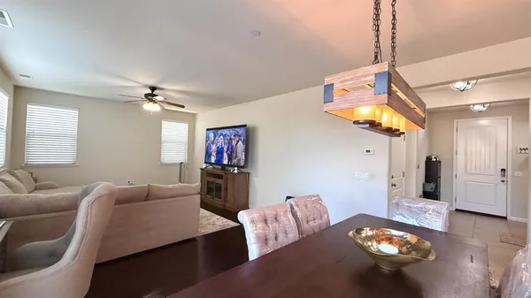 a living room with furniture and a chandelier