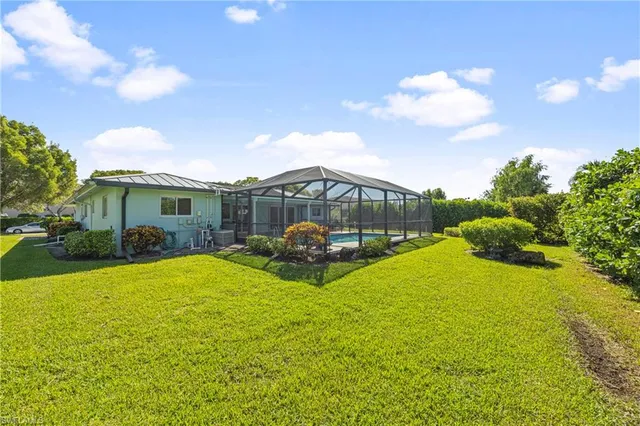 a view of a house with backyard and patio