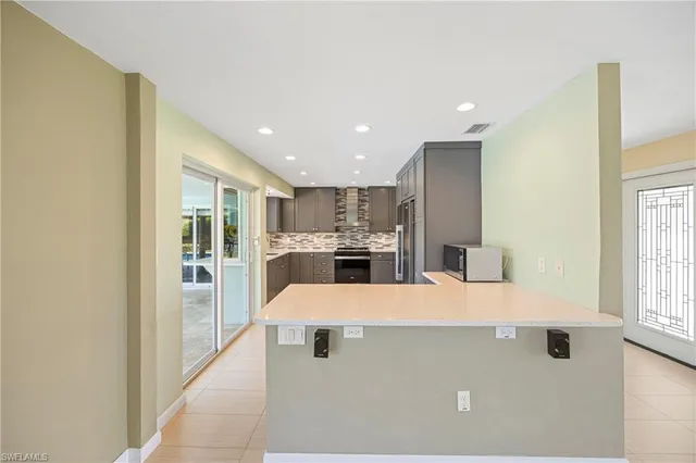 a large kitchen with a table and chairs