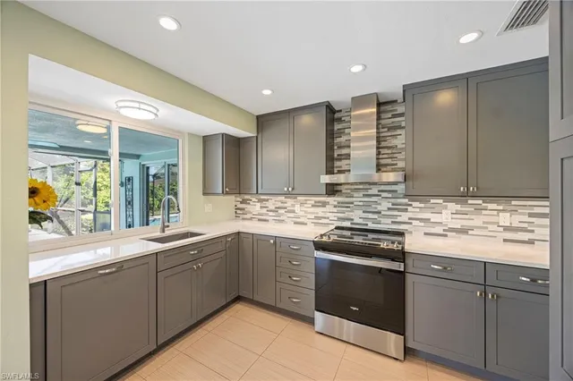 a kitchen with stainless steel appliances granite countertop a sink and stove top oven