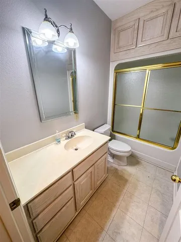 a bathroom with a sink a toilet and vanity
