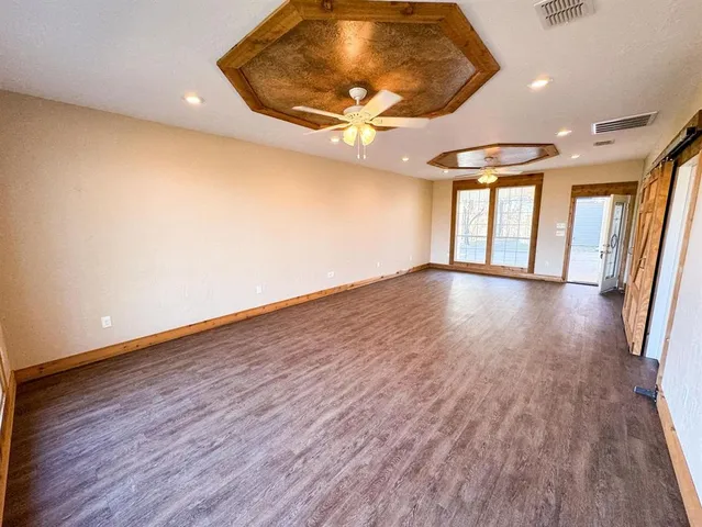 a view of an entryway with wooden floor