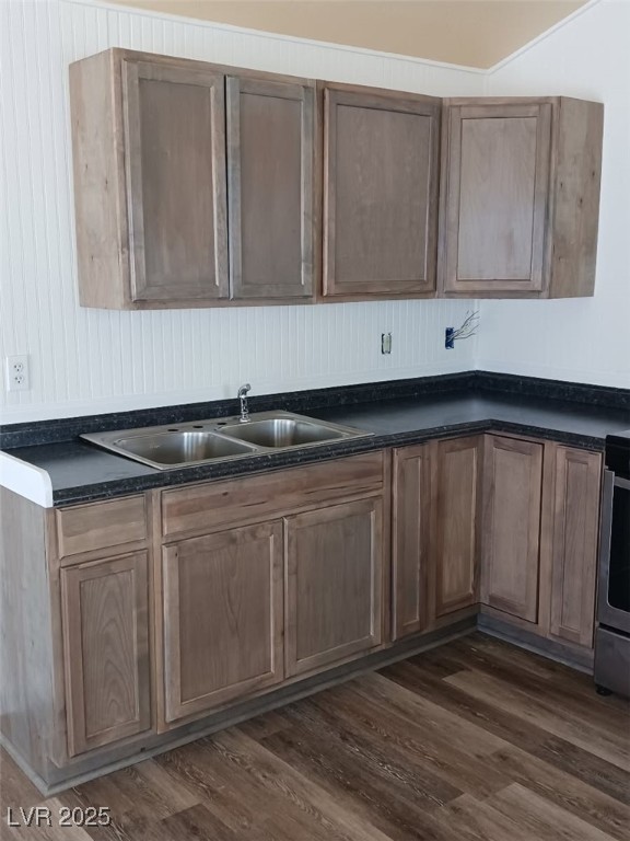 1208 Broadway Street Goldfield, NV 89013 - Photo 18 of 23 Kitchen featuring a sink, stove, dark wood-type flooring, and dark countertops