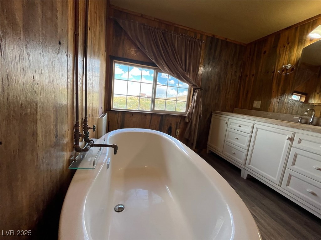 1208 Broadway Street Goldfield, NV 89013 - Photo 10 of 23 Full bath featuring vanity, wood walls, and a freestanding bath