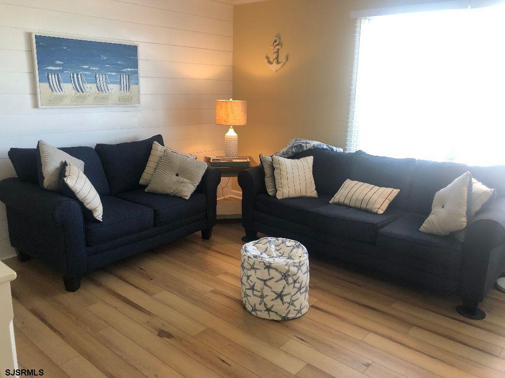107 East Brigantine Avenue, Unit 211 Brigantine, NJ 08203 - Photo 19 of 34 a living room with furniture and a wooden floor