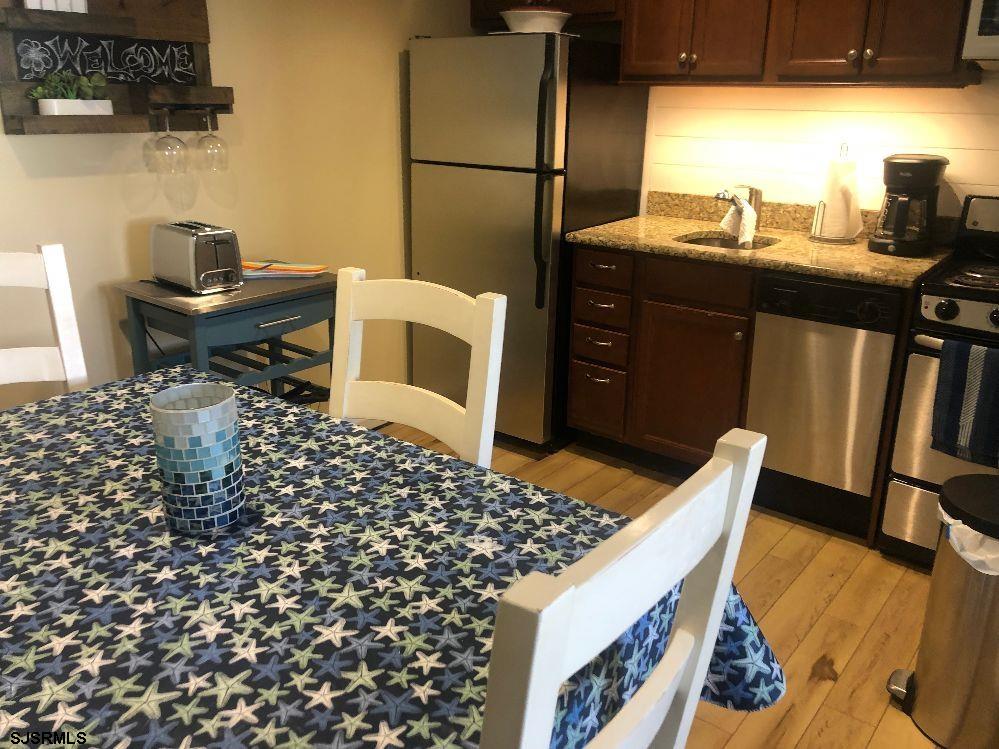 107 East Brigantine Avenue, Unit 211 Brigantine, NJ 08203 - Photo 21 of 34 a living room with a couch and a table