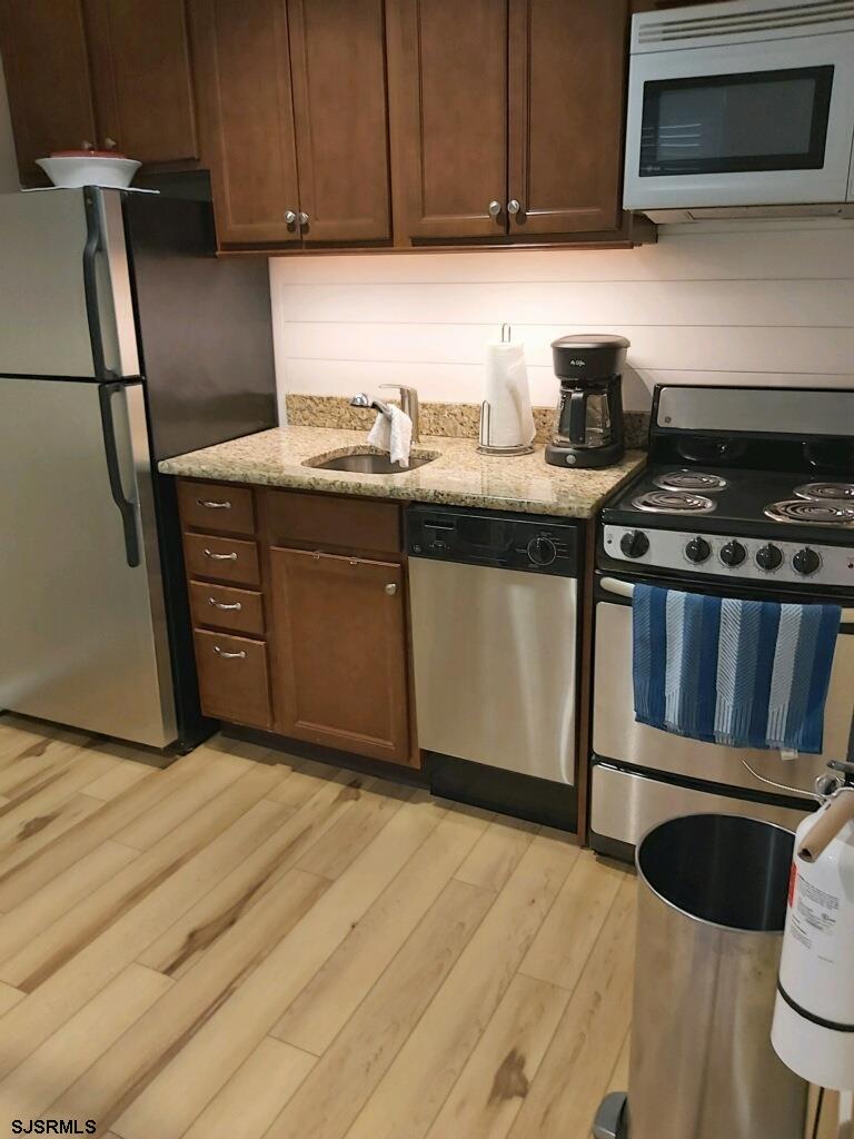 107 East Brigantine Avenue, Unit 211 Brigantine, NJ 08203 - Photo 22 of 34 a kitchen with a sink stove and cabinets