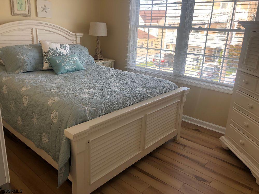 107 East Brigantine Avenue, Unit 211 Brigantine, NJ 08203 - Photo 26 of 34 a bed sitting in a bedroom next to a window
