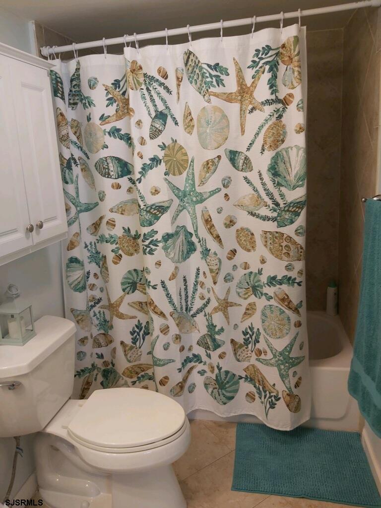 107 East Brigantine Avenue, Unit 211 Brigantine, NJ 08203 - Photo 28 of 34 a white toilet sitting next to a shower curtain