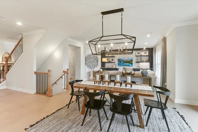 a kitchen with stainless steel appliances kitchen island a table and chairs in it