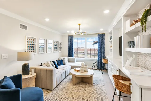 a living room with furniture fireplace and a large window