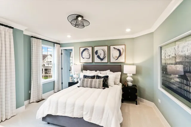 a bedroom with a large bed and a chandelier