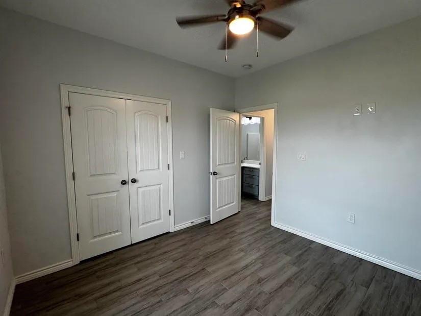 2295 Diamond D Lane Beaumont, TX 77713 - Photo 20 of 40 a view of an empty room with wooden floor and a ceiling fan