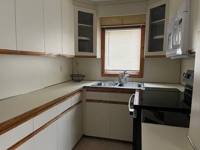 a kitchen with a sink cabinets and window