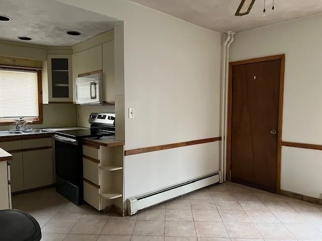 a kitchen with stainless steel appliances granite countertop a refrigerator and a stove
