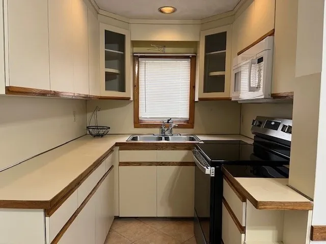 a kitchen that has a sink and a stove