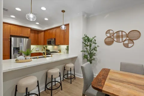a view of a dining room with furniture and wooden floor
