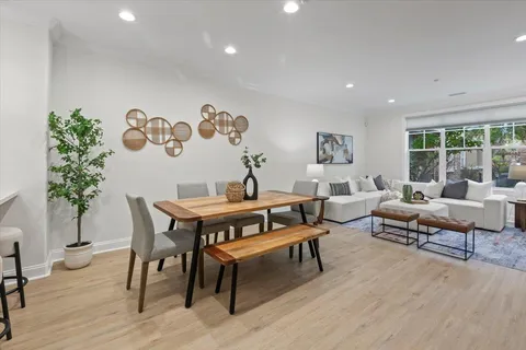 a living room with furniture wooden floor and a large window