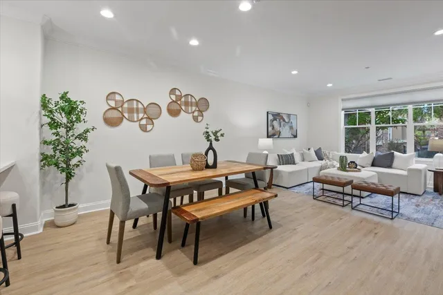 a living room with furniture wooden floor and a large window
