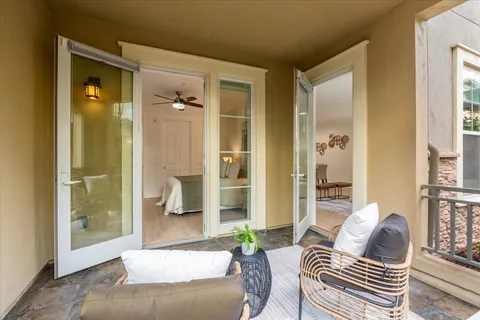 a balcony with couch and wooden floor