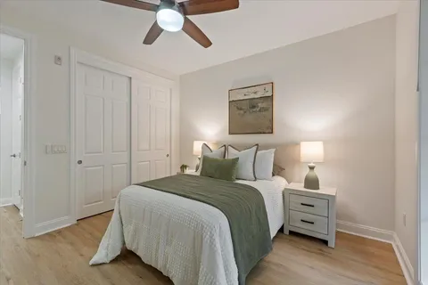 a bedroom with a bed couch and a window