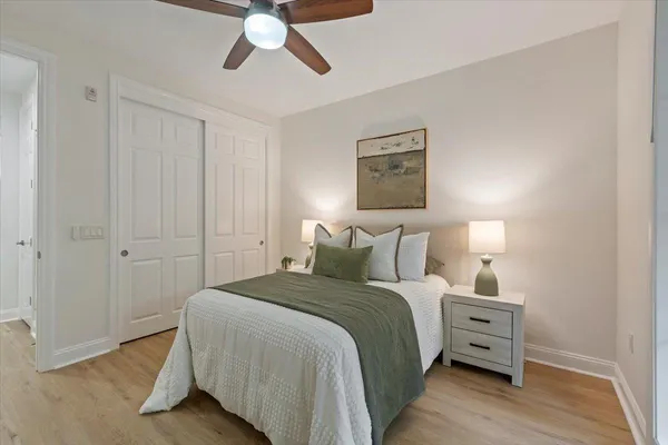 a bedroom with a bed couch and a window