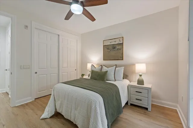 a bedroom with a bed couch and a window