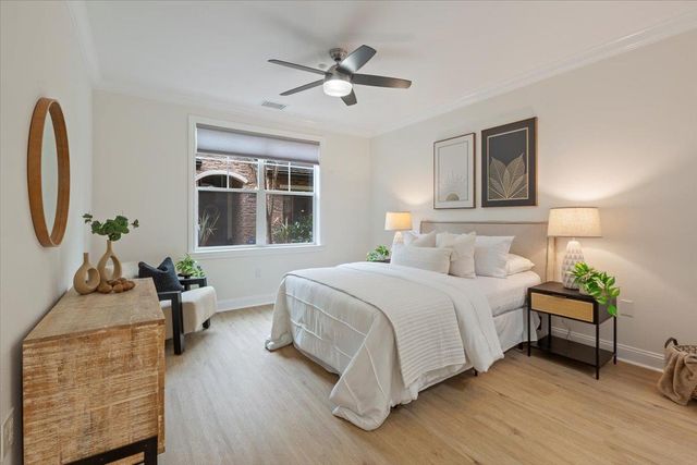 a bedroom with bed and a chandelier