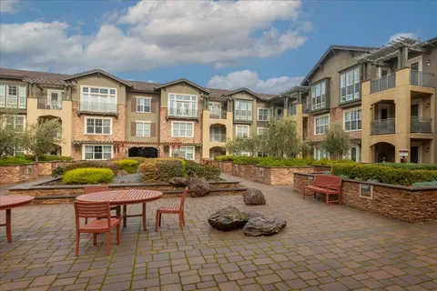 a view of a house with swimming pool and sitting area