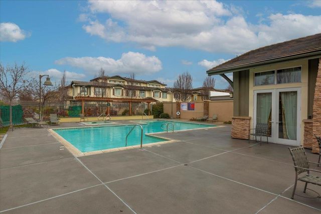 a view of a house with swimming pool and sitting area