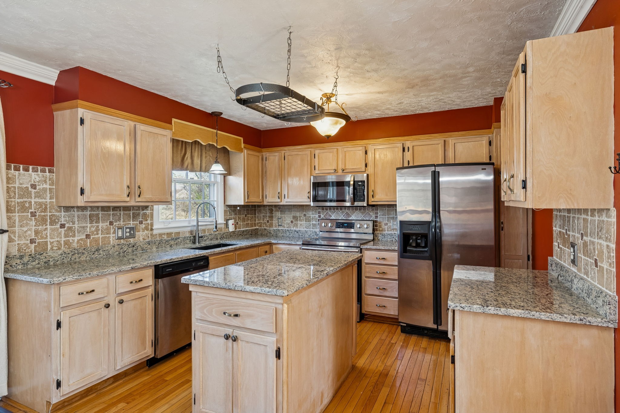 7424 George Gaines Road Nashville, TN 37221 - Photo 12 of 60 a kitchen with stainless steel appliances granite countertop a sink a stove a refrigerator cabinets and wooden floor