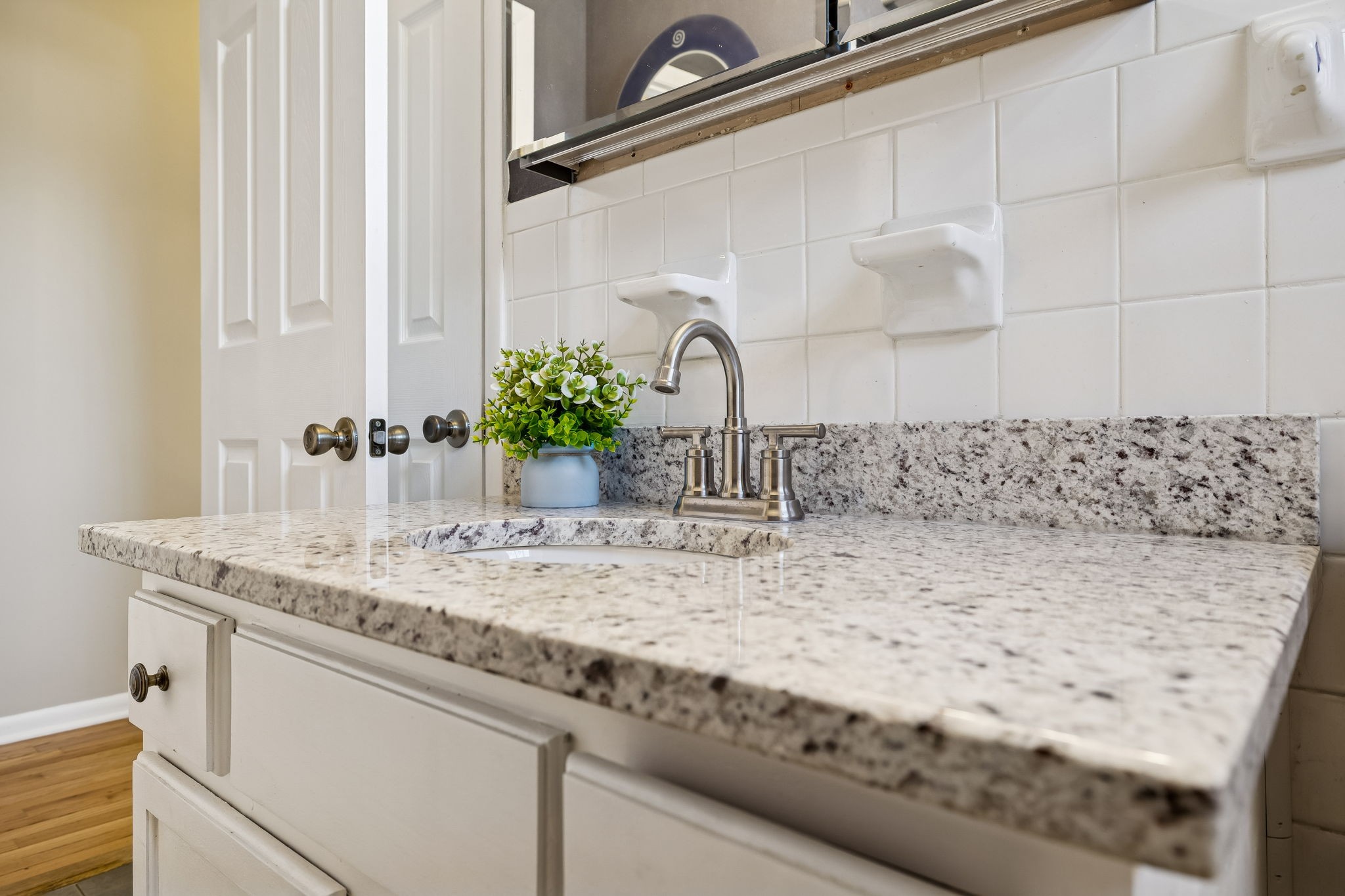 7424 George Gaines Road Nashville, TN 37221 - Photo 15 of 60 a bathroom with a granite countertop sink and a mirror