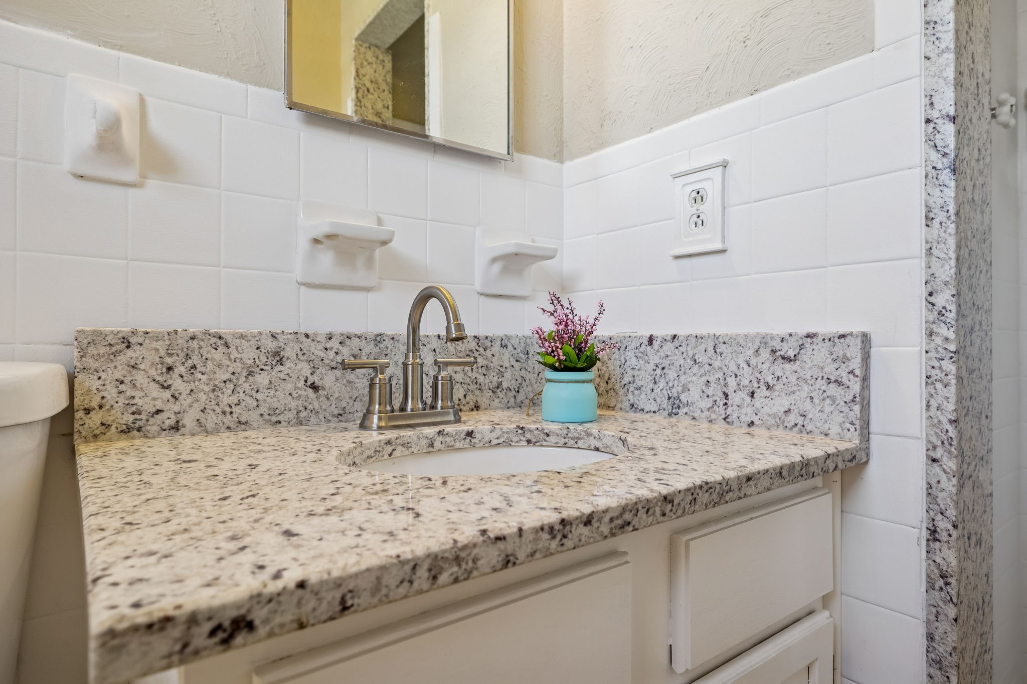 7424 George Gaines Road Nashville, TN 37221 - Photo 19 of 60 a bathroom with a granite countertop sink and a mirror