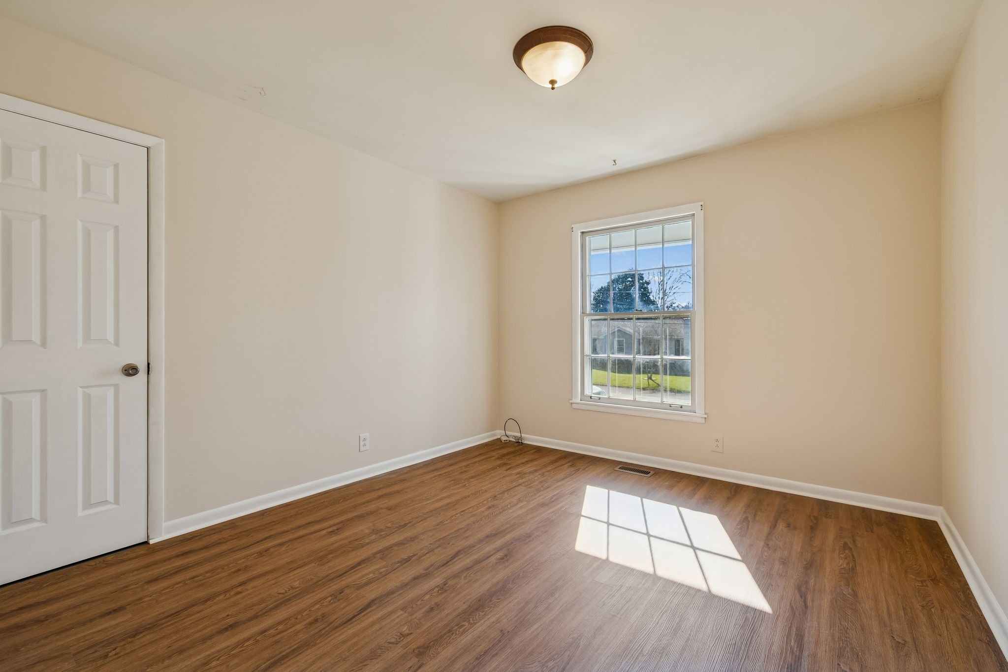 7424 George Gaines Road Nashville, TN 37221 - Photo 23 of 60 an empty room with wooden floor and windows