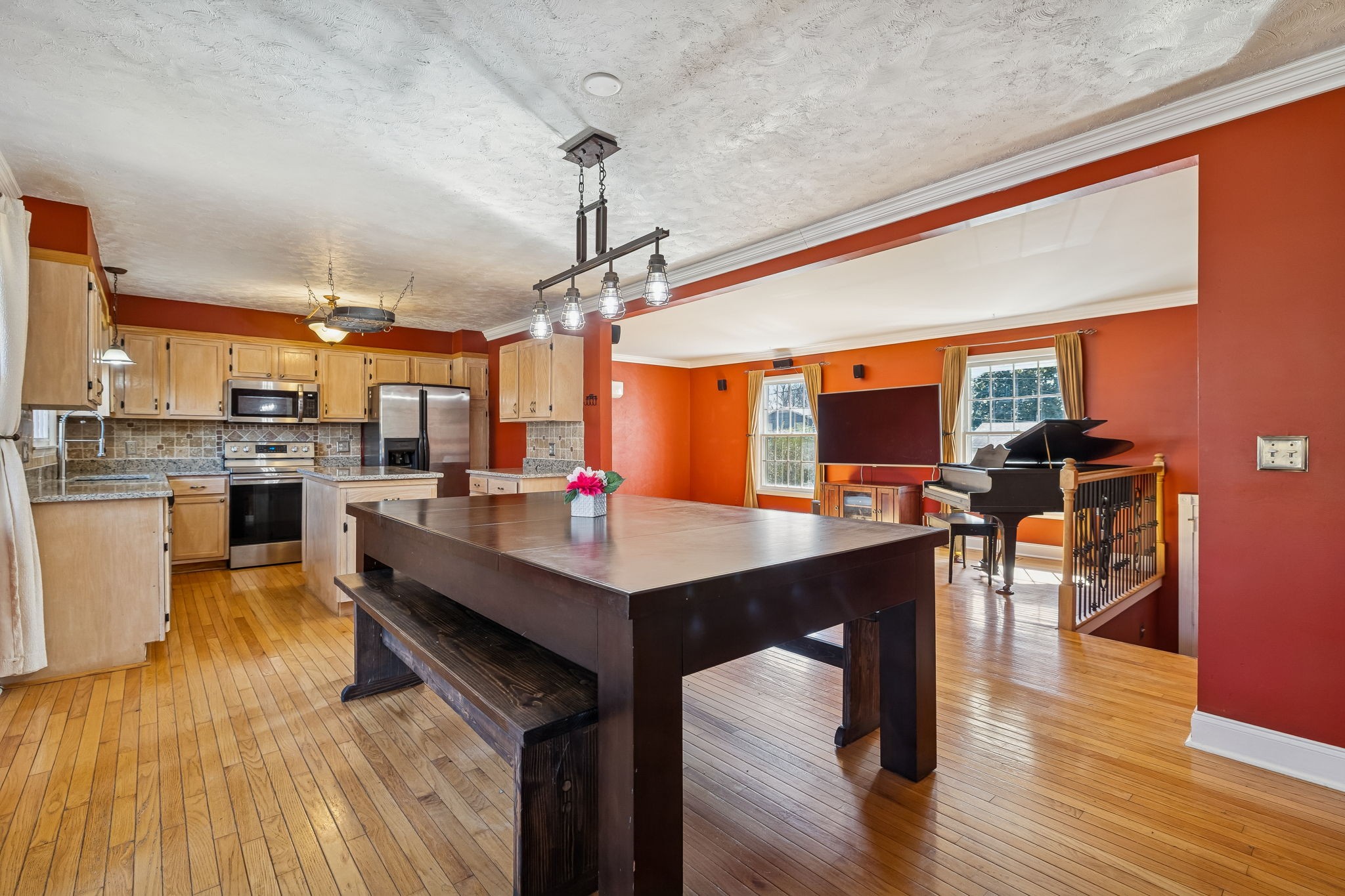 7424 George Gaines Road Nashville, TN 37221 - Photo 10 of 60 a kitchen with stainless steel appliances wooden floor dining table and chairs