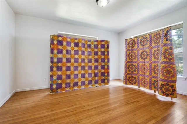 a view of room with window and wooden floor