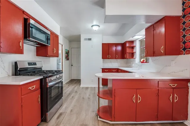 a kitchen with stainless steel appliances granite countertop a stove and a refrigerator