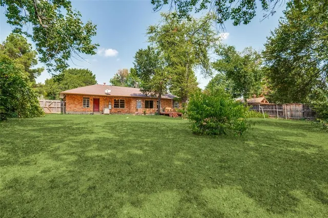 a backyard of a house with table and chairs