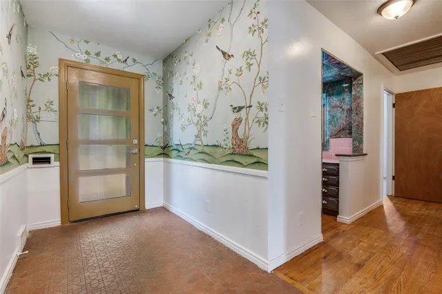 a view of empty room with a fireplace and cabinet