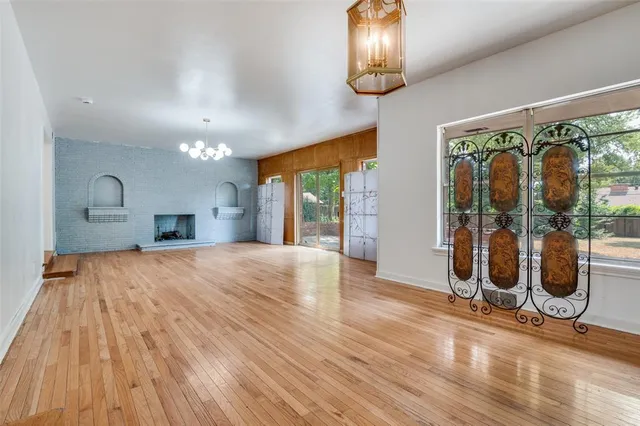 a room with wooden floor and windows