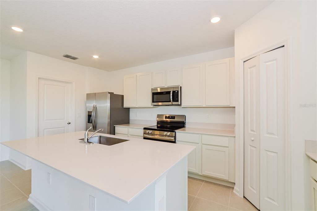4061 Old Ml Road Haines City, FL 33844 - Photo 11 of 15 a kitchen with refrigerator and microwave