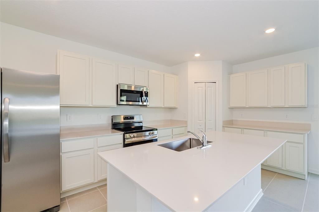 4061 Old Ml Road Haines City, FL 33844 - Photo 10 of 15 a kitchen with stainless steel appliances a refrigerator a stove a microwave and cabinets