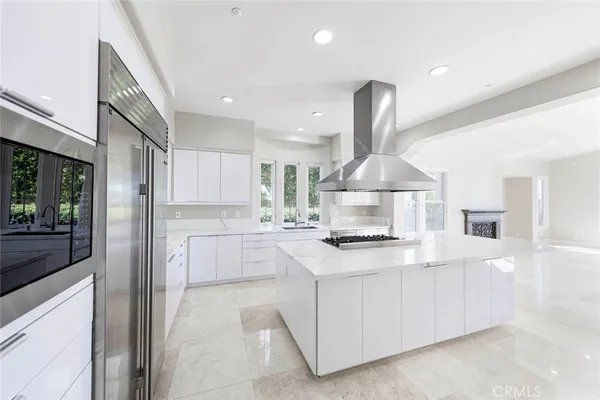 a kitchen with a stove and white cabinets