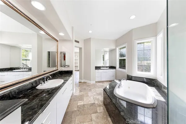 a large white kitchen with a large window