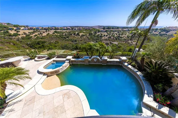 a view of a swimming pool with a table and chairs