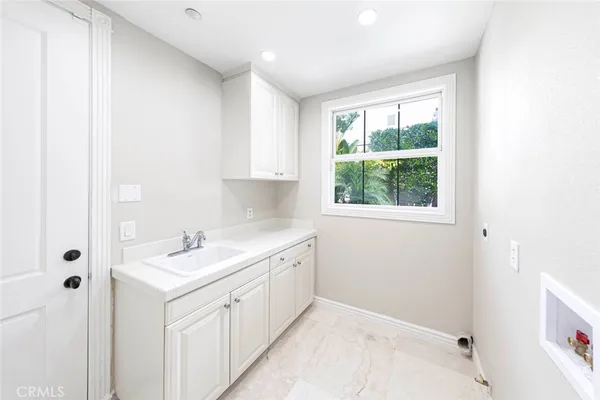 a spacious bathroom with a sink and a window