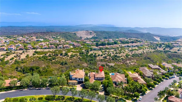 an aerial view of residential building and trees around